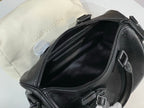 Louis Vuitton bag open top with black leather interior and zipper closure