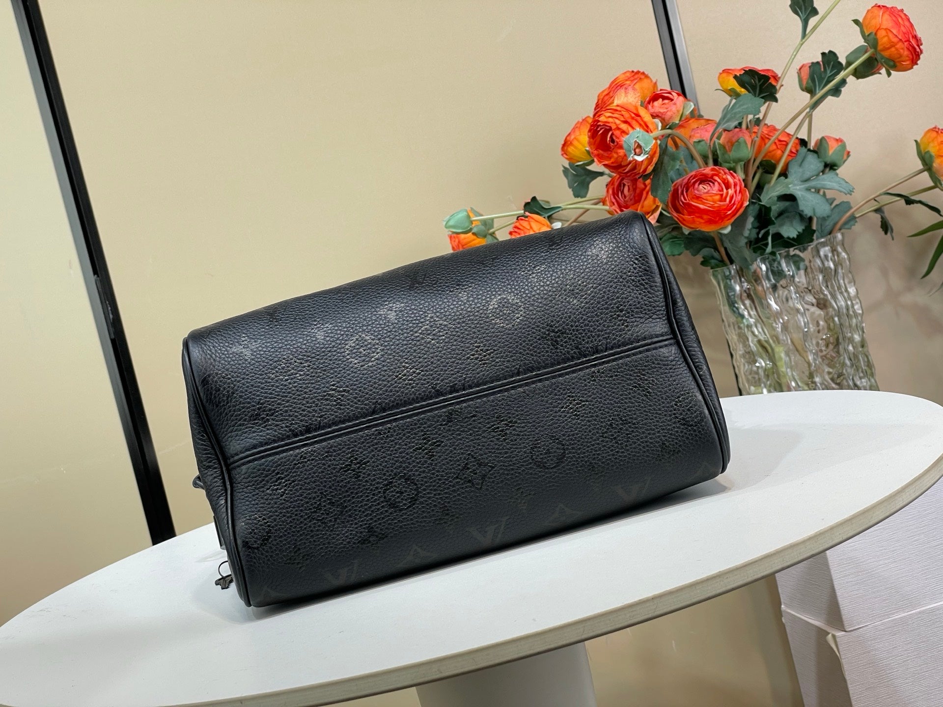 Black leather flap crossbody bag with adjustable strap and front logo pattern
