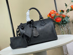 Black leather top-handle tote bag with shoulder strap and front charm accessories