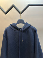 Navy blue zip-up hoodie with drawstring hood and subtle embossed pattern