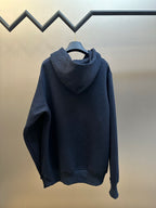 Navy blue hooded sweatshirt with kangaroo pocket and long sleeves