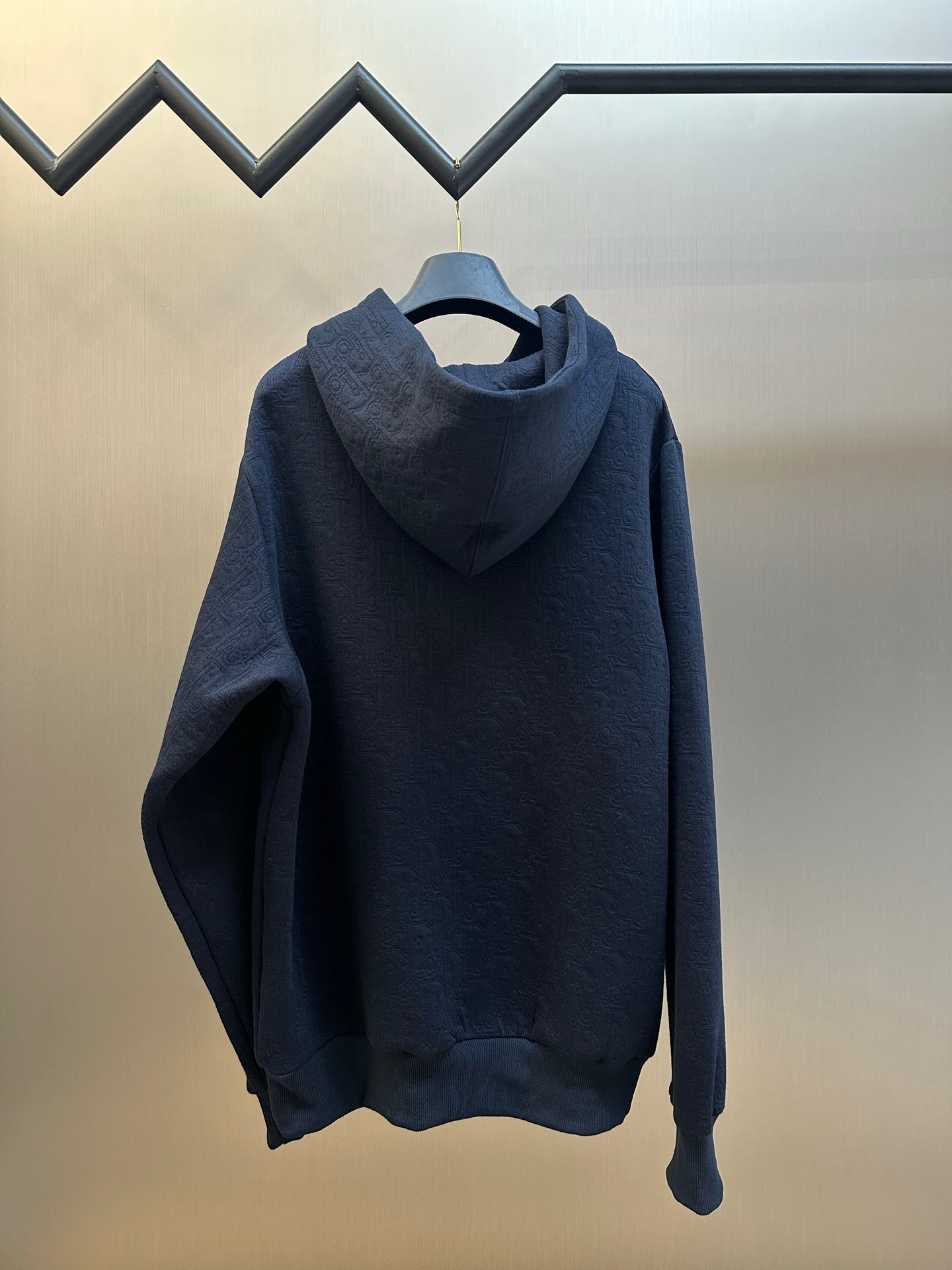 Navy blue hooded sweatshirt with kangaroo pocket and long sleeves