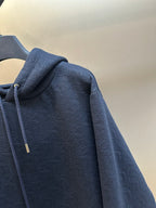 Navy blue hoodie with textured fabric and drawstring hood on the side