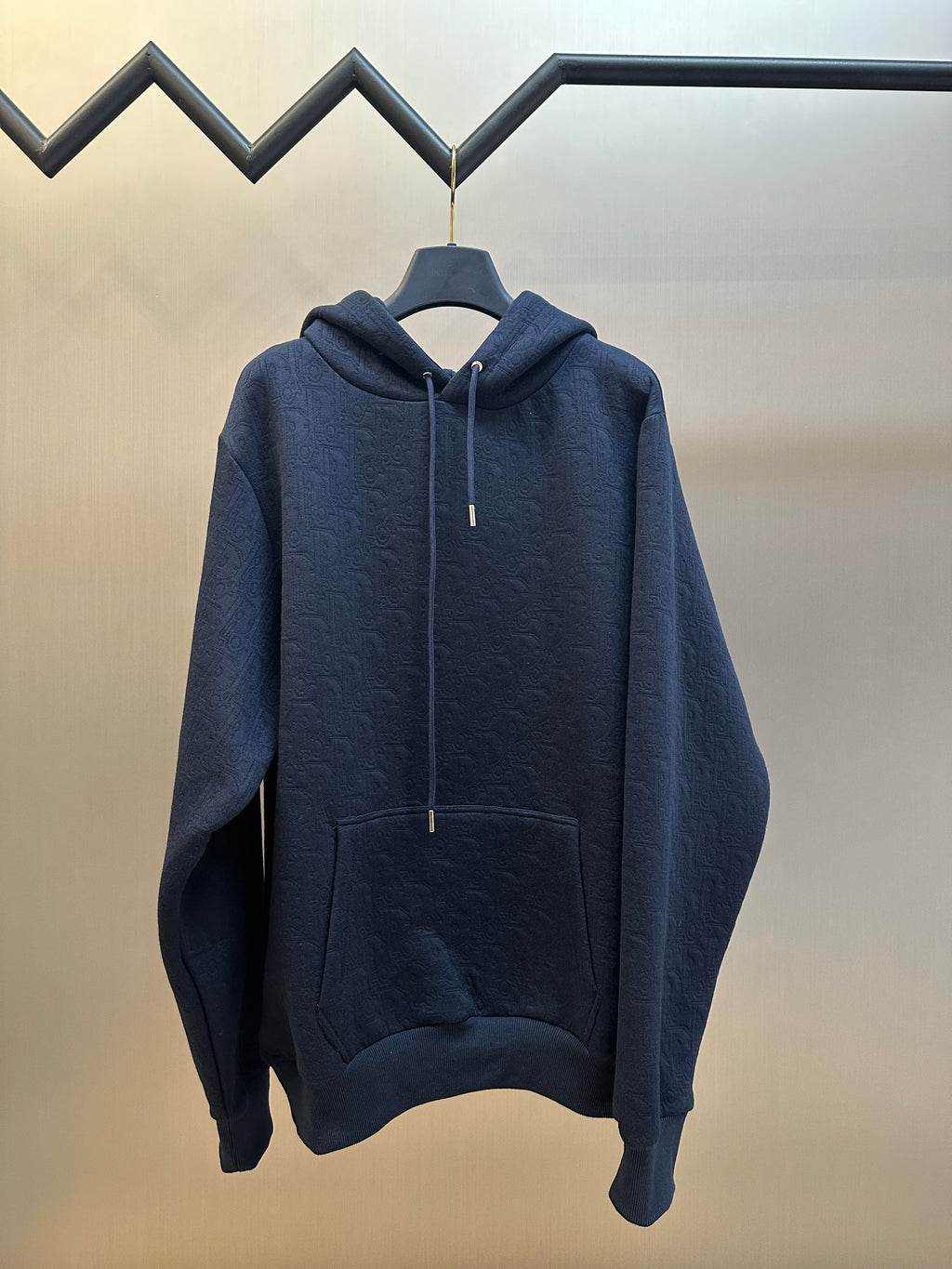 Navy blue hooded sweatshirt with front pocket and long sleeves