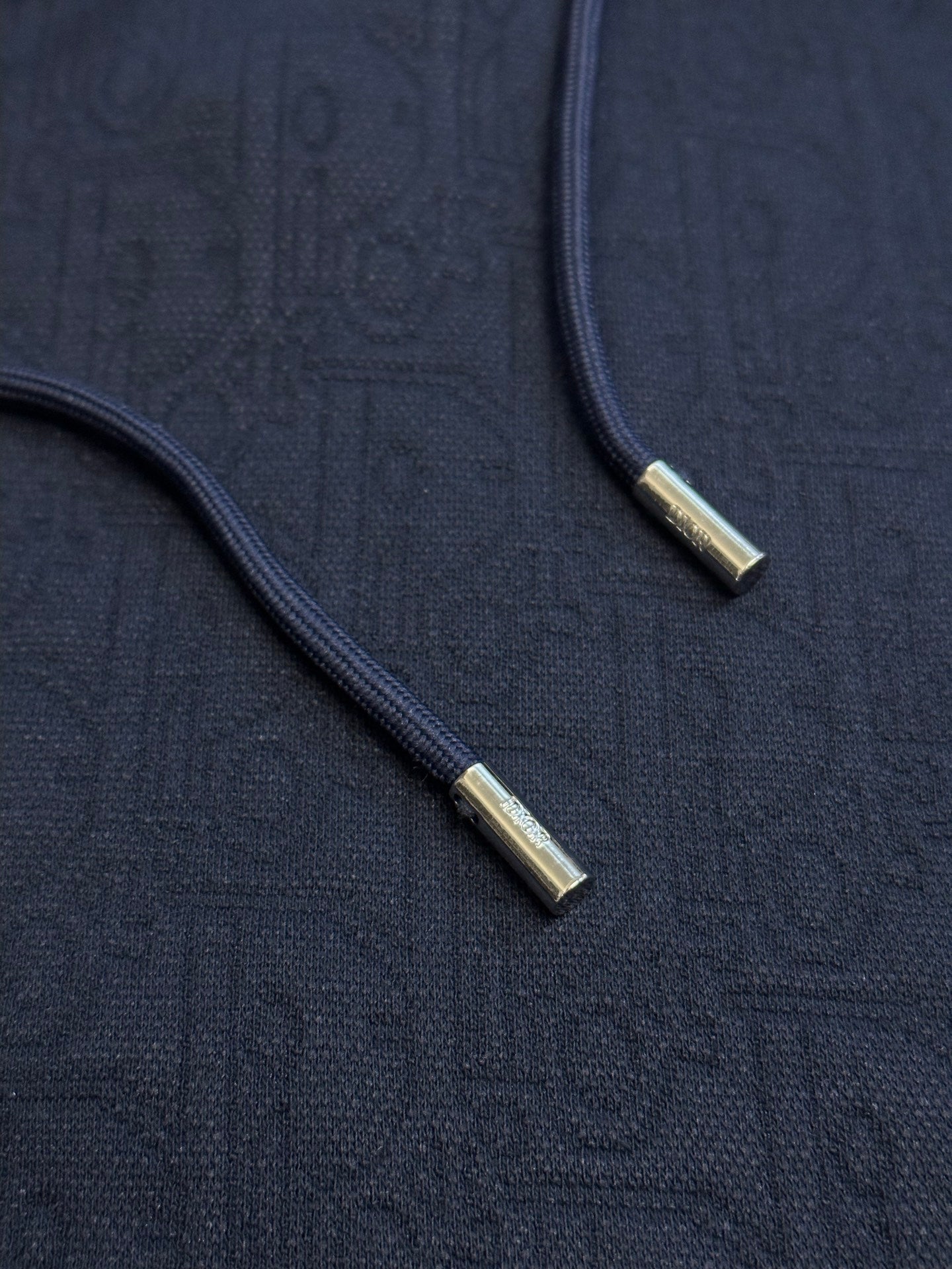 Navy blue hoodie front zipper with gold-tone zipper pulls