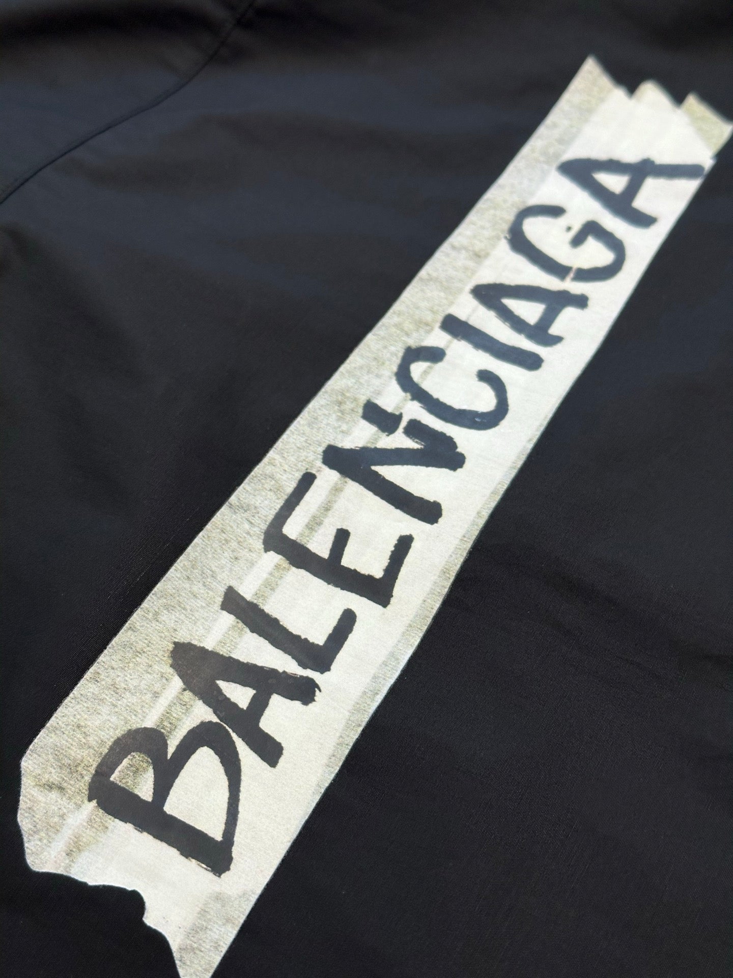 Dark charcoal shirt with large Balenciaga logo patch on chest area