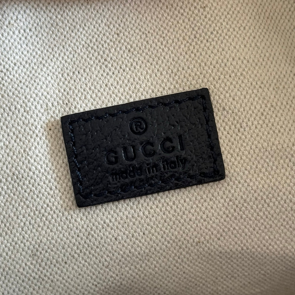 Gucci bag interior label patch with Gucci logo on black leather