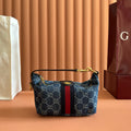 Gucci bag in blue GG canvas with red stripe, gold zipper and top handle
