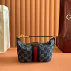 Gucci bag in blue GG canvas with red center stripe, gold zipper and shoulder handle