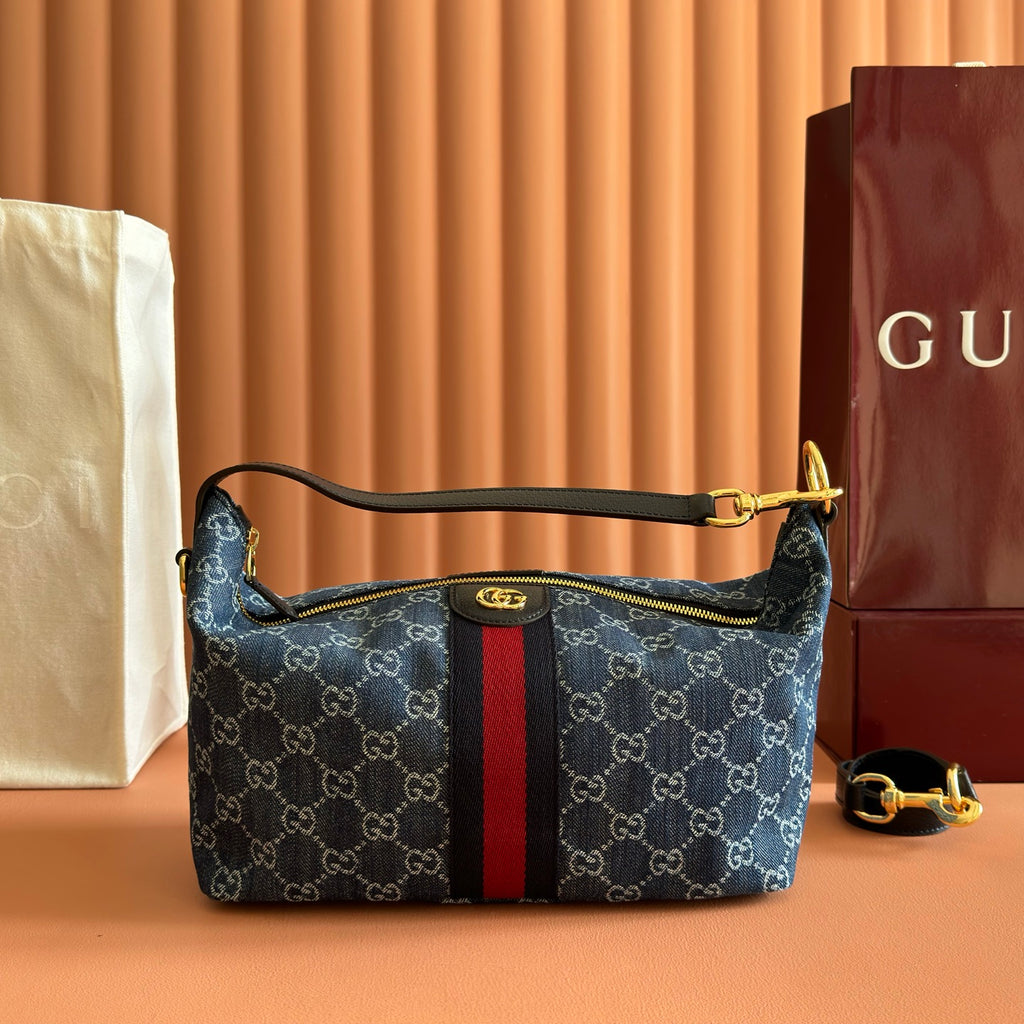 Gucci bag in blue GG canvas with red/black stripe, top zip and gold handles.