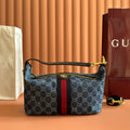 Gucci bag in blue GG canvas with red/black stripe, top zip and gold handles.