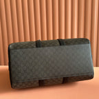 Two-tone duffel bag with long black shoulder strap and dark logo canvas front