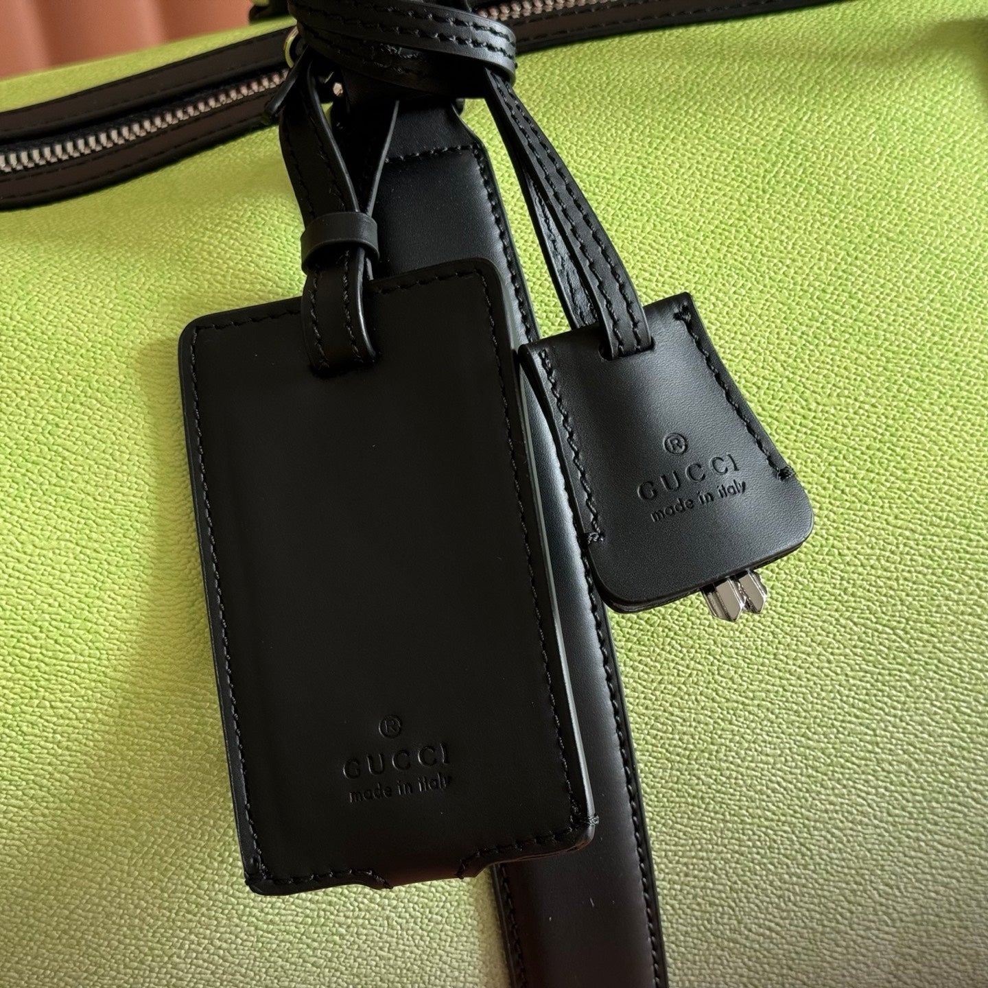 Gucci duffel bag charm tag with black leather holder on lime green leather