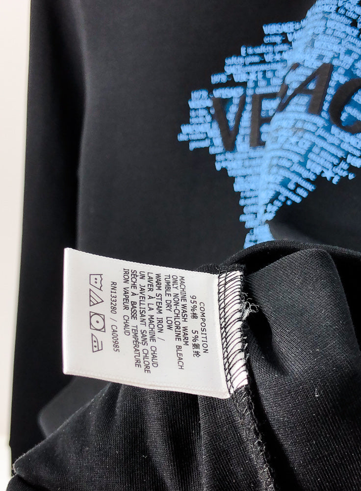 Black crewneck sweatshirt inner seam and care label near collar
