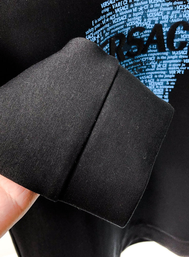 Black crewneck sweatshirt fabric close-up with textured knit