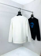 White crewneck sweatshirt back view hanging with black sweatshirt beside it