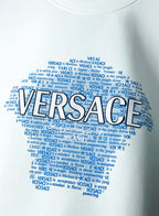 White sweatshirt close-up of large blue Versace logo text across chest