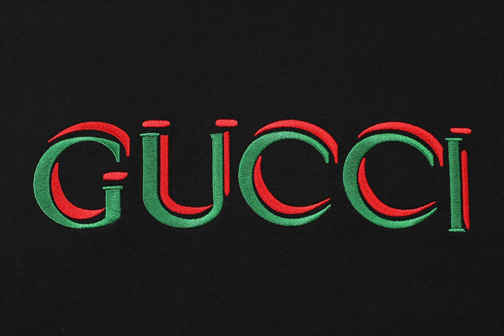 Black T-shirt chest graphic: multicolor Gucci logo in red and green