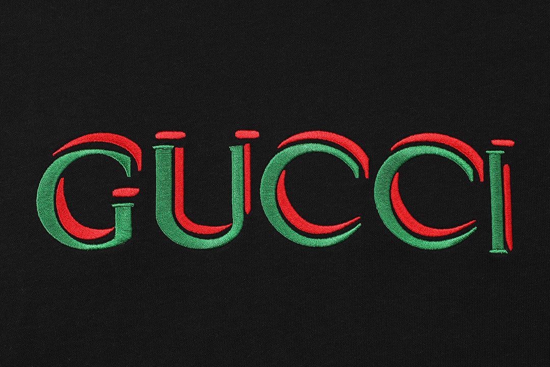Black T-shirt chest graphic: multicolor Gucci logo in red and green
