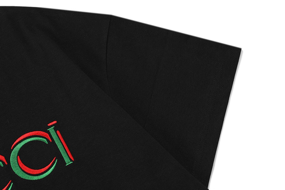 Black T-shirt angled view showing partial Gucci logo and short sleeves