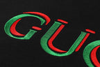 Gucci lettering detail on black T-shirt in red and green