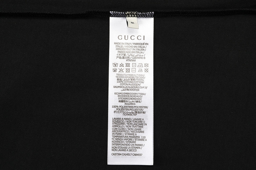 Black shorts care label with GUCCI text