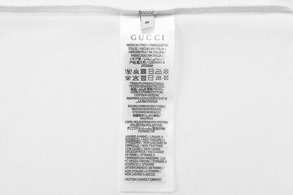 Gucci short care label on white fabric tag