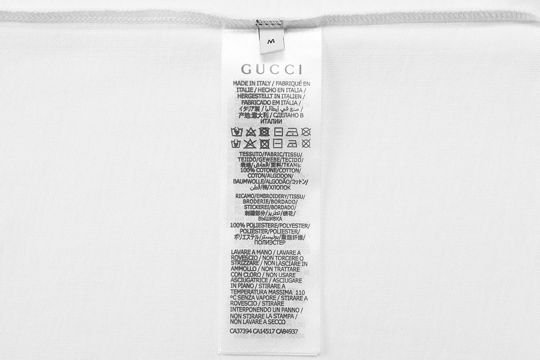 Gucci short care label on white fabric tag