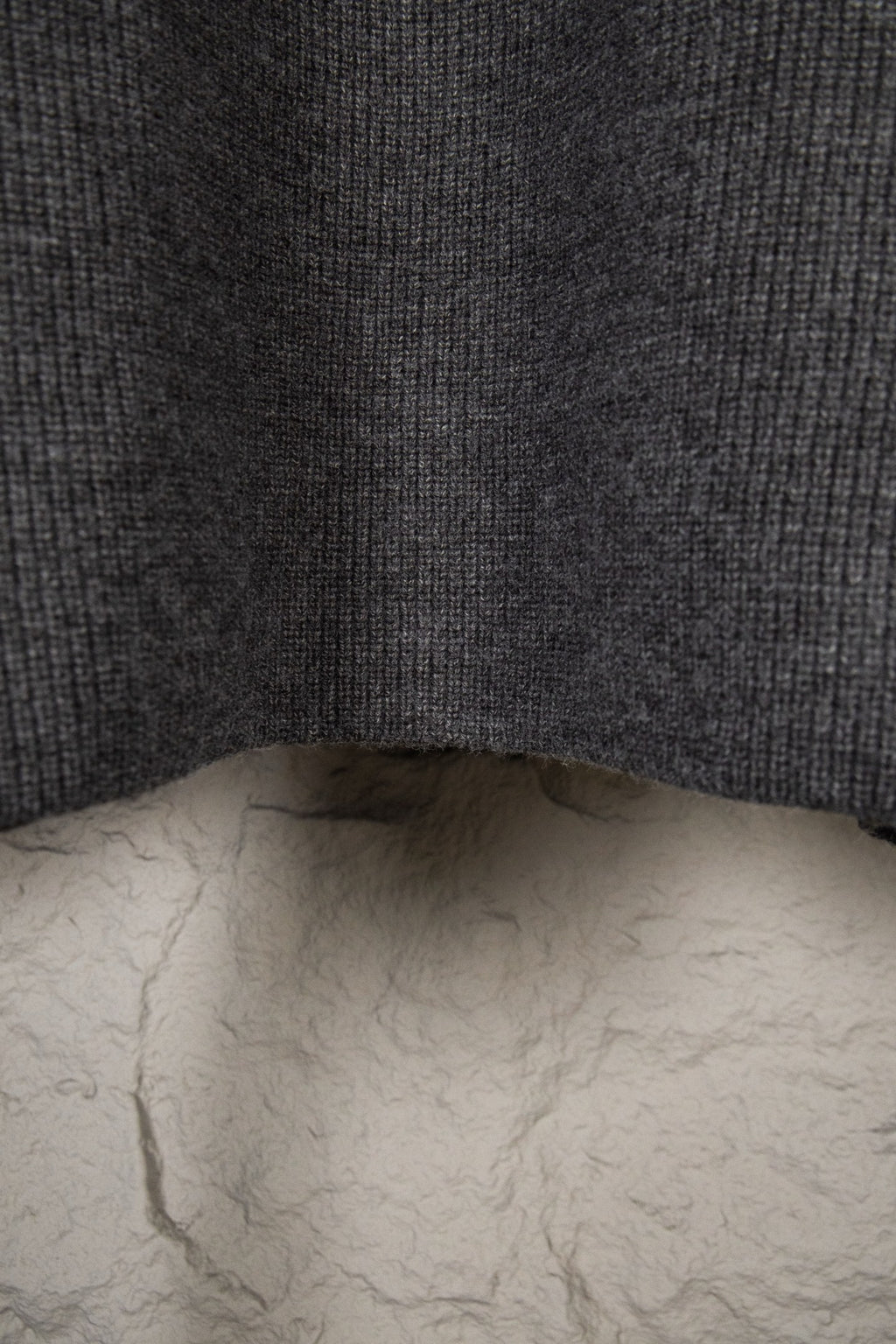 Dark gray knit sweater back with ribbed hem detail