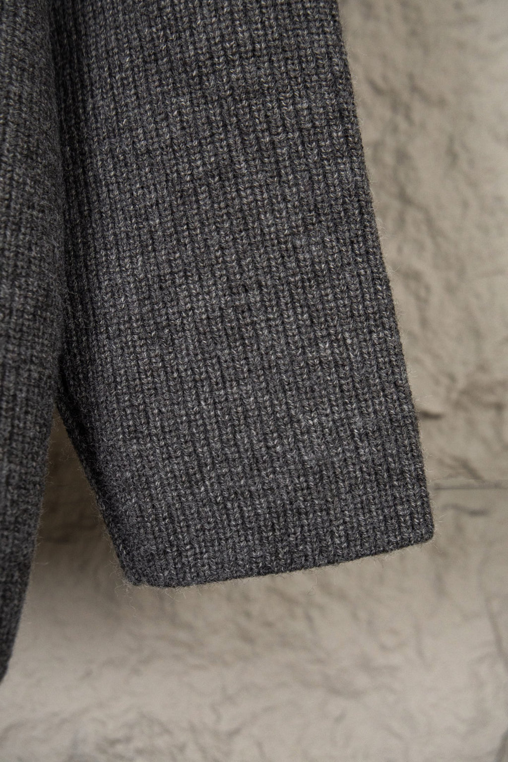 Dark gray knit sweater with ribbed hem and textured knit