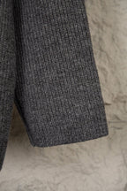 Dark gray knit sweater with ribbed hem and textured knit