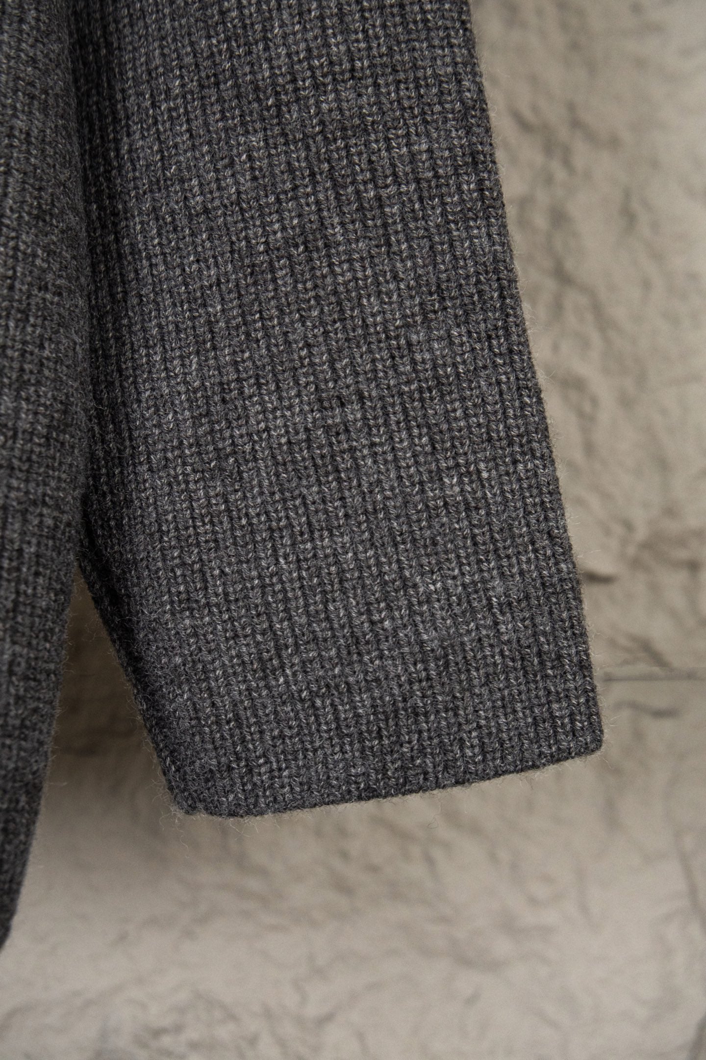 Dark gray knit sweater with ribbed hem and textured knit