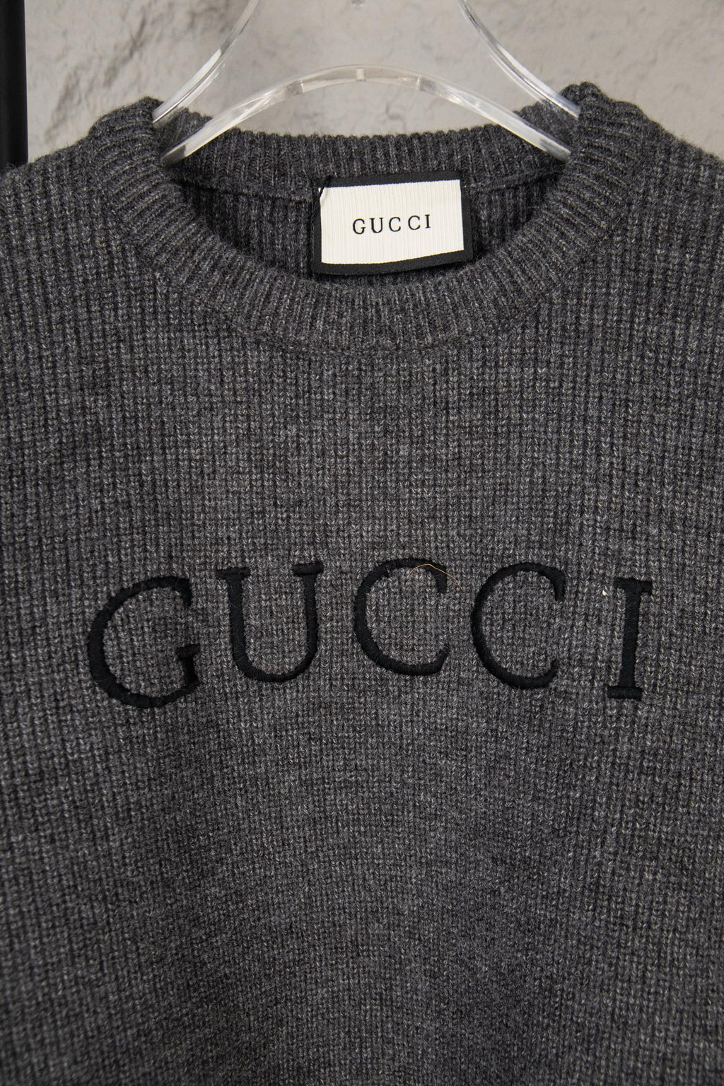 Dark gray knit sweater with large GUCCI logo print