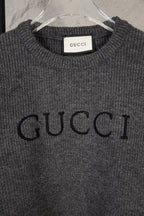 Dark gray knit sweater with large GUCCI logo print