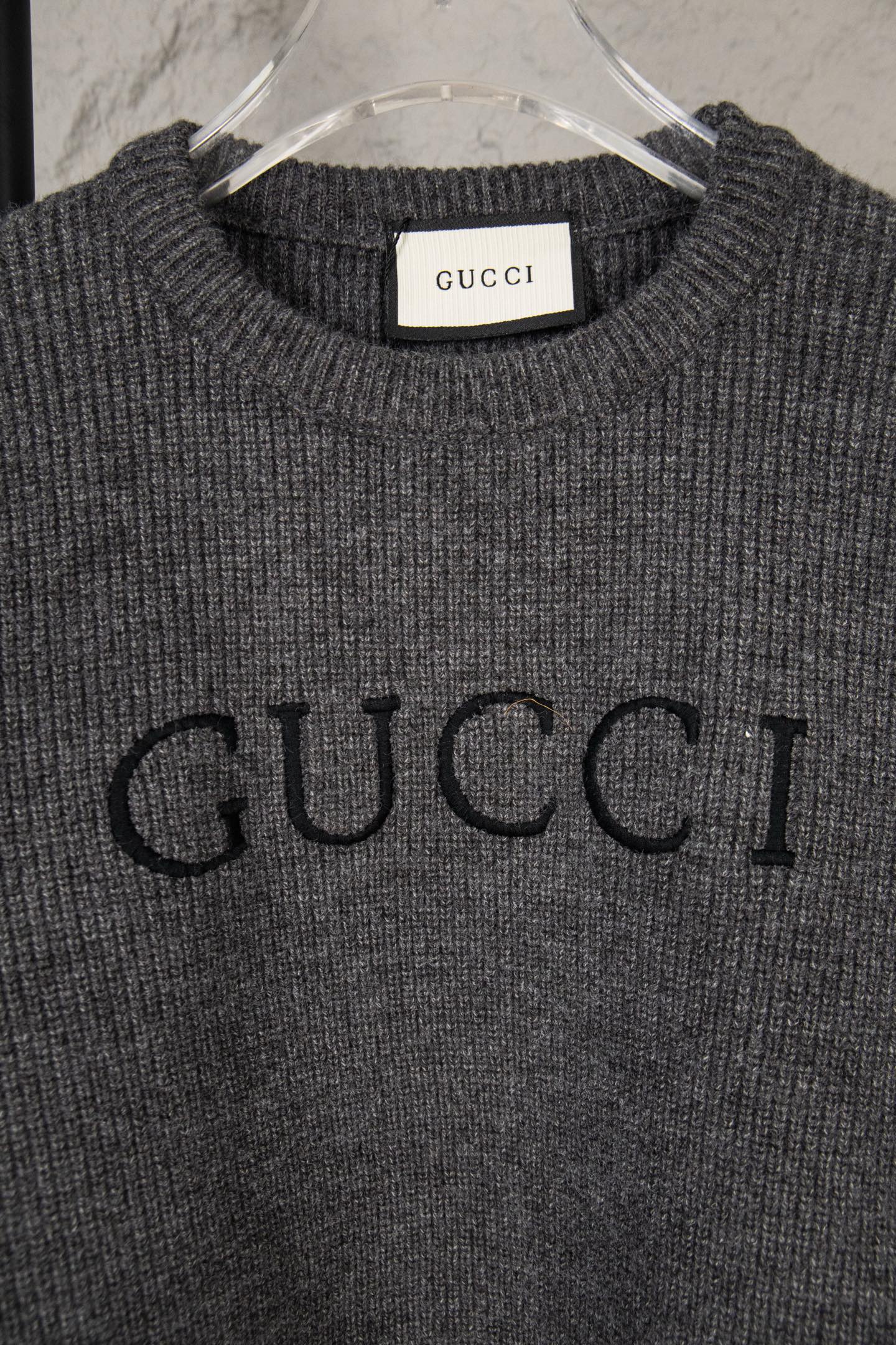 Dark gray knit sweater with large GUCCI logo print