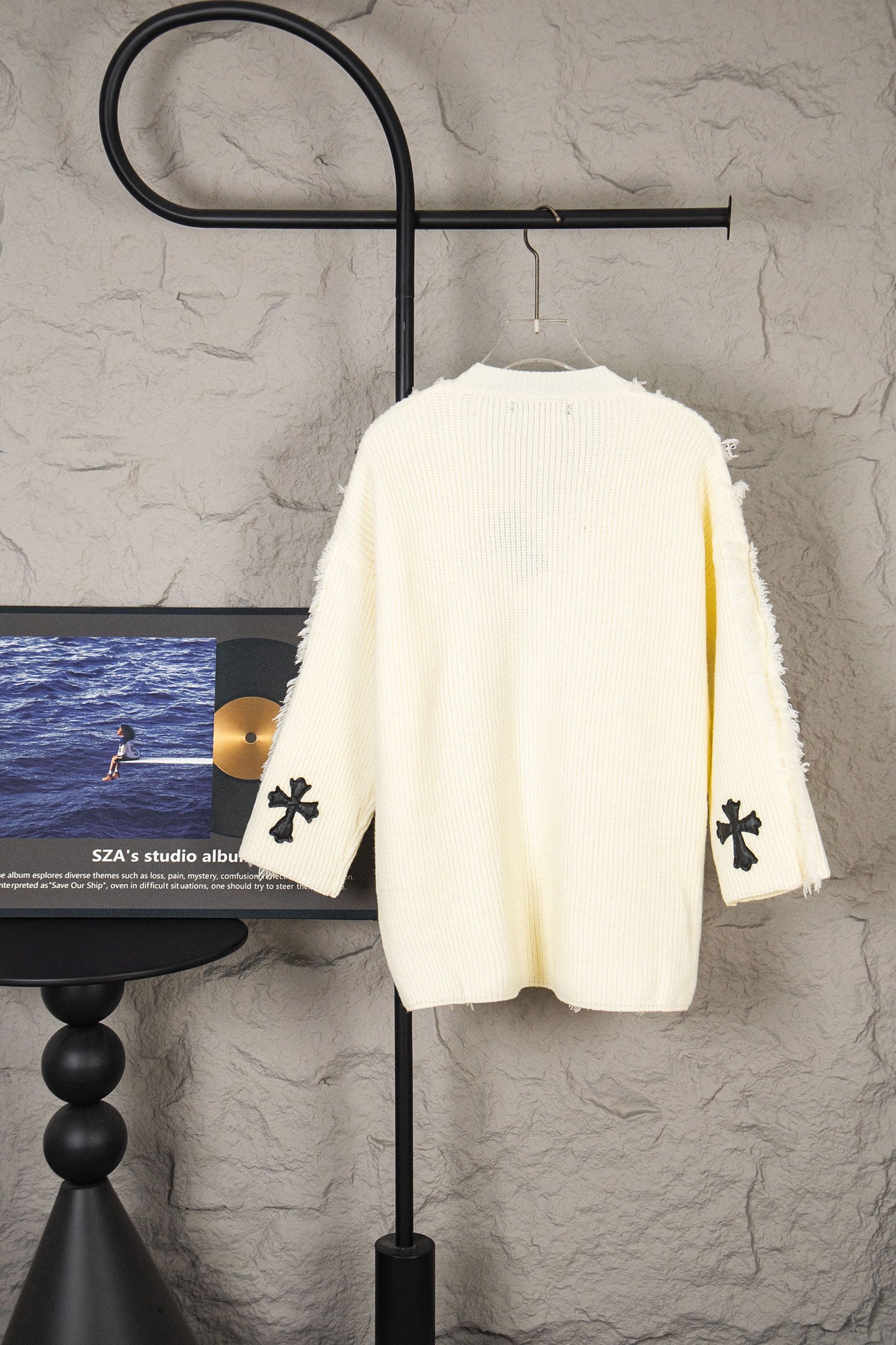 Off-white knit sweater back with small black clover cross appliques