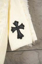 Off-white knit sweater cuff area with small black clover cross applique