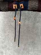 Adjustable drawstring cords with leather-style tips on the jacket hem