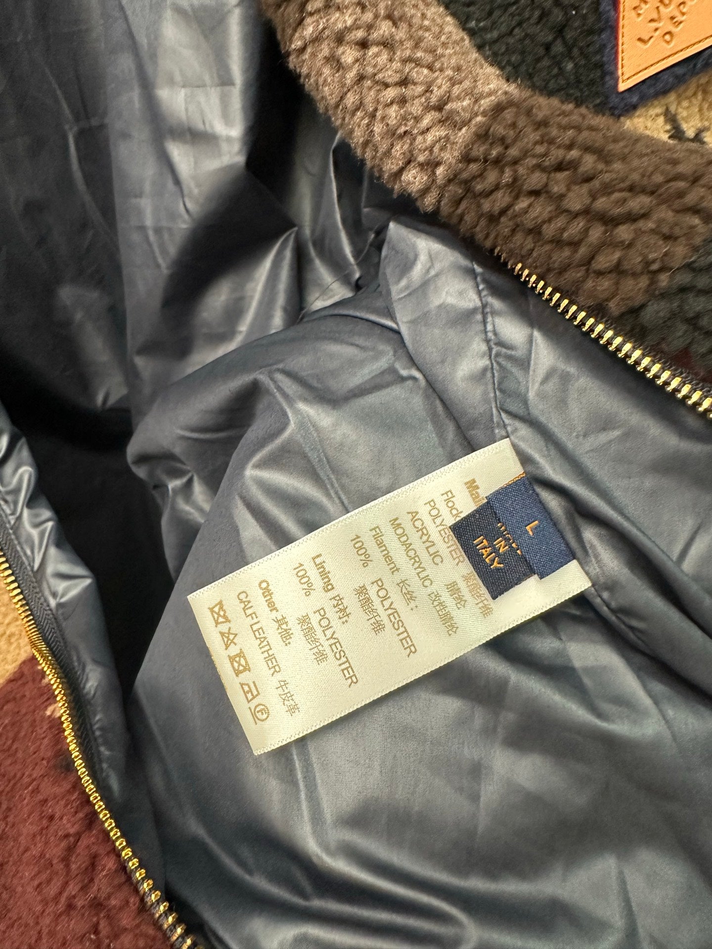 Jacket interior lining tag near zipper, with Louis Vuitton label