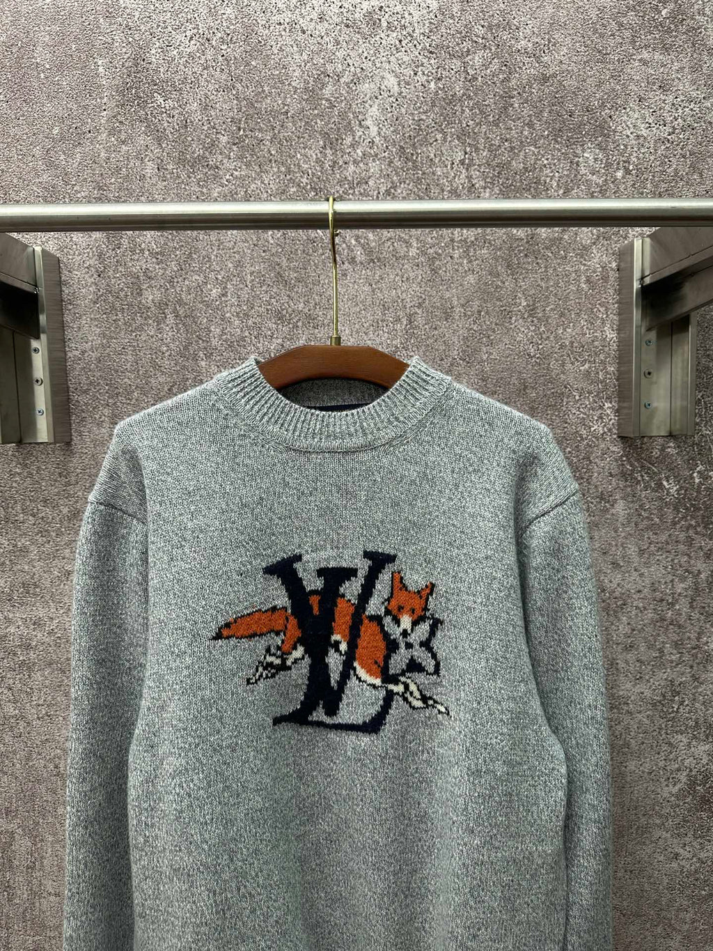 Louis Vuitton knit sweater front close-up in light blue with logo graphic