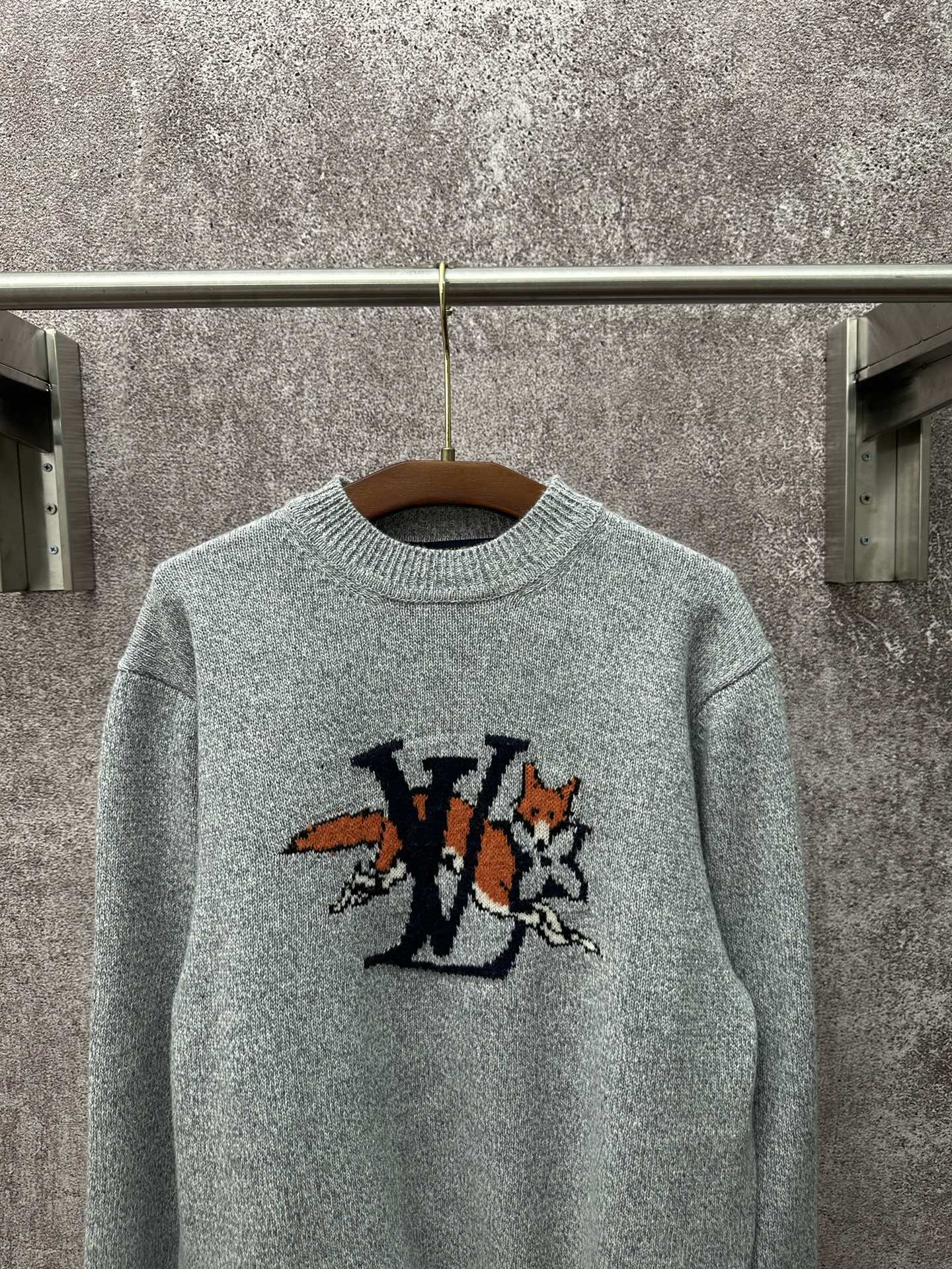 Louis Vuitton knit sweater front close-up in light blue with logo graphic