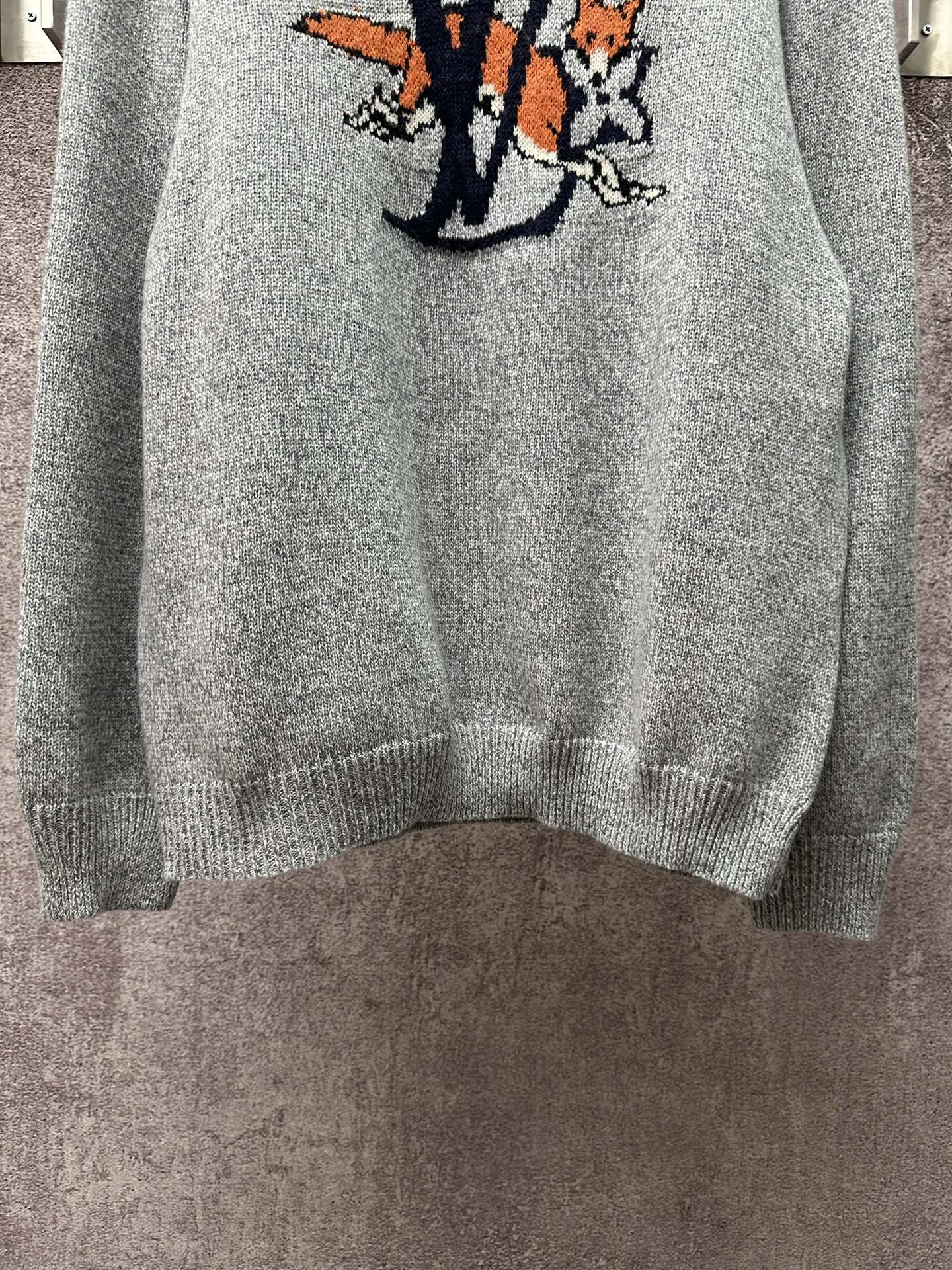 Louis Vuitton knit sweater lower front view in light blue with logo graphic