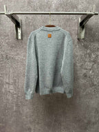 Louis Vuitton knit sweater back view in light blue with small logo patch