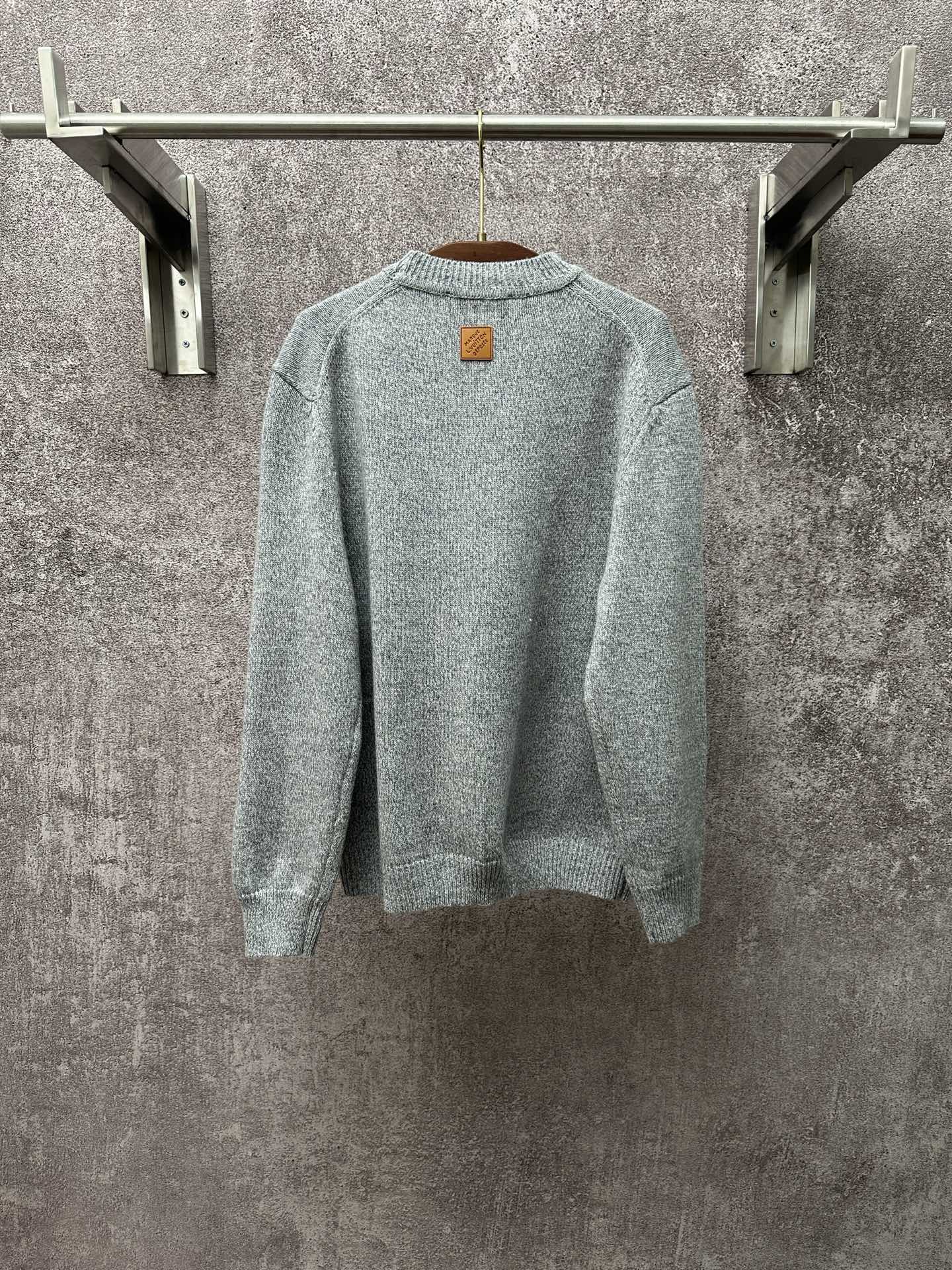 Louis Vuitton knit sweater back view in light blue with small logo patch
