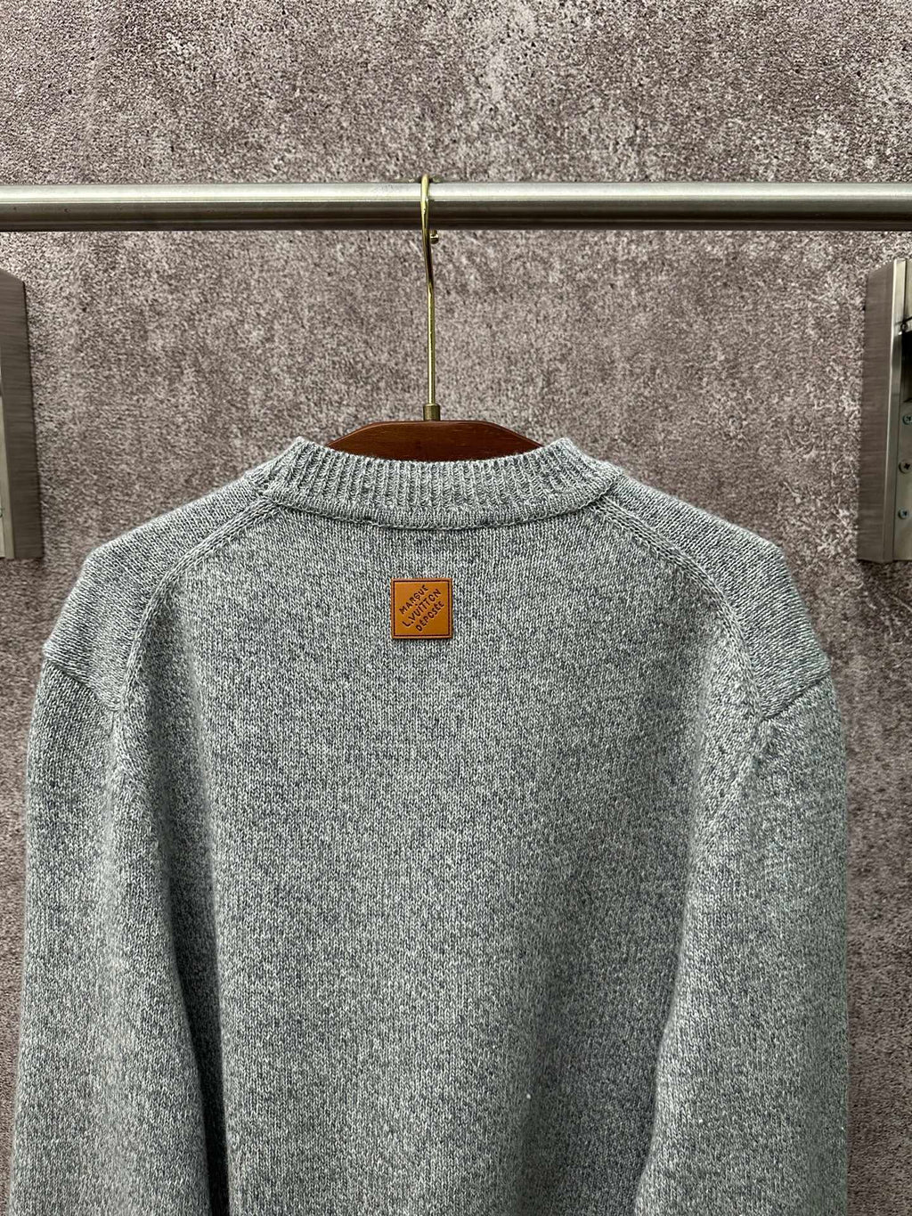 Louis Vuitton knit sweater back neckline close-up in light blue with logo patch