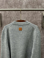 Louis Vuitton knit sweater back neckline close-up in light blue with logo patch
