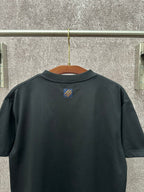 Dark T-shirt back view with small crest logo at upper center