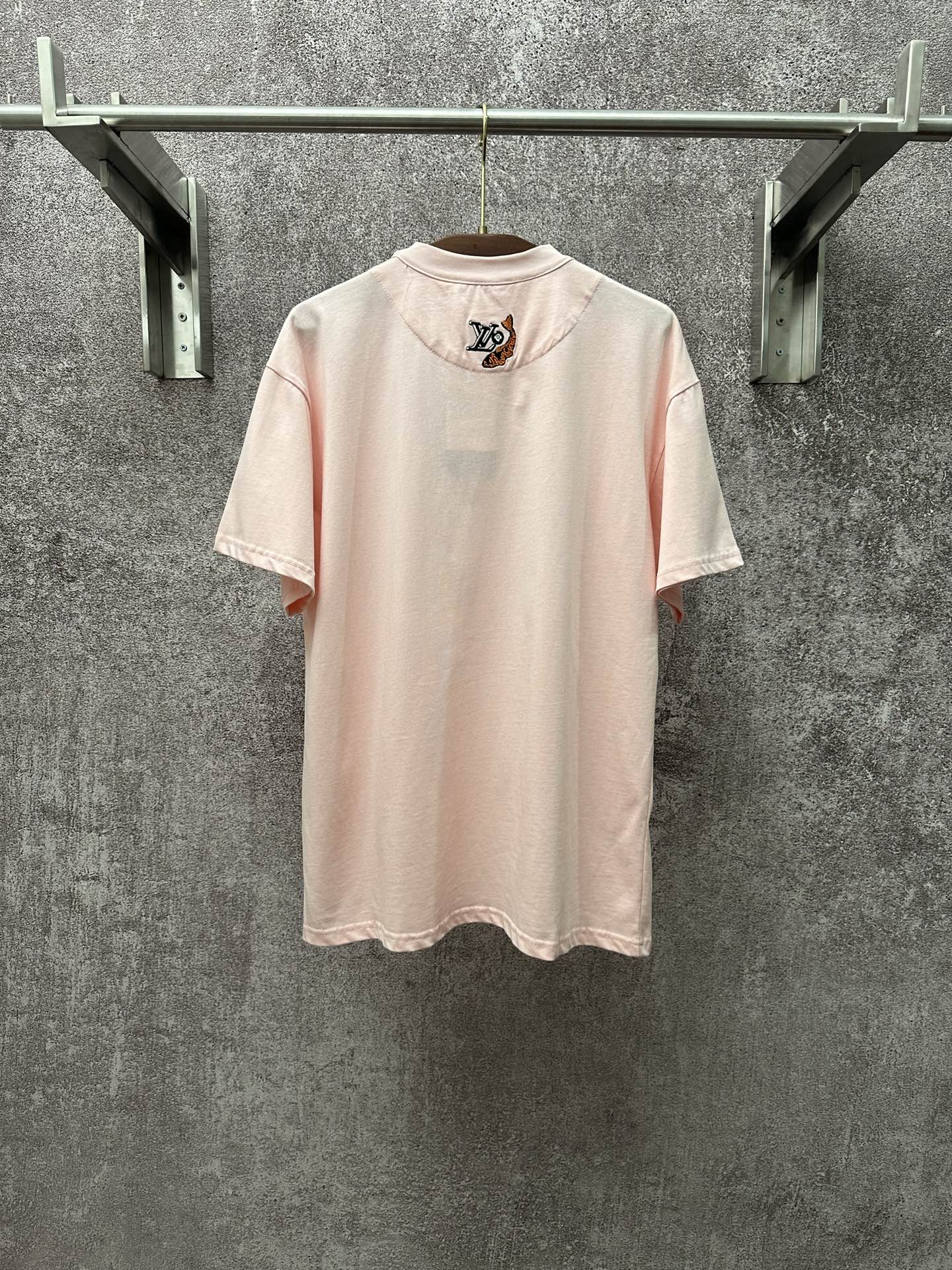 Louis Vuitton pale pink T-shirt with small LV emblem on back, crew neck, short sleeves