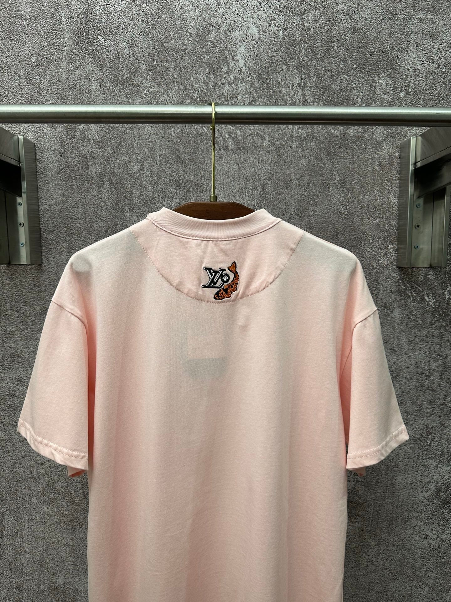 Louis Vuitton pale pink T-shirt back view with small LV emblem near upper back