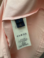 Louis Vuitton fabric care label inside pale pink T-shirt with symbols and sizing